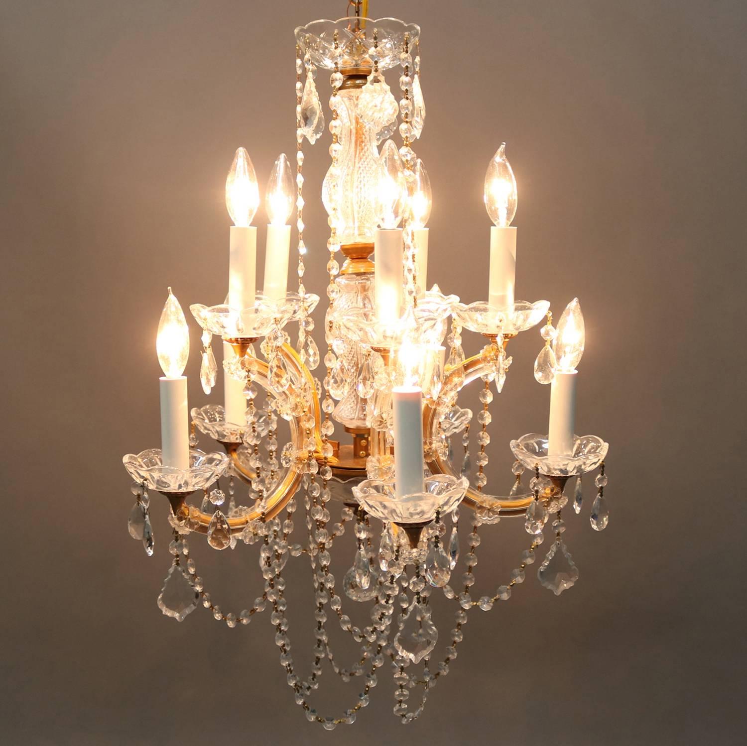 French crystal chandelier features gilt c-scroll form frame with ten lights decorated with hanging and strung cut crystals, 20th century

Measures - 52