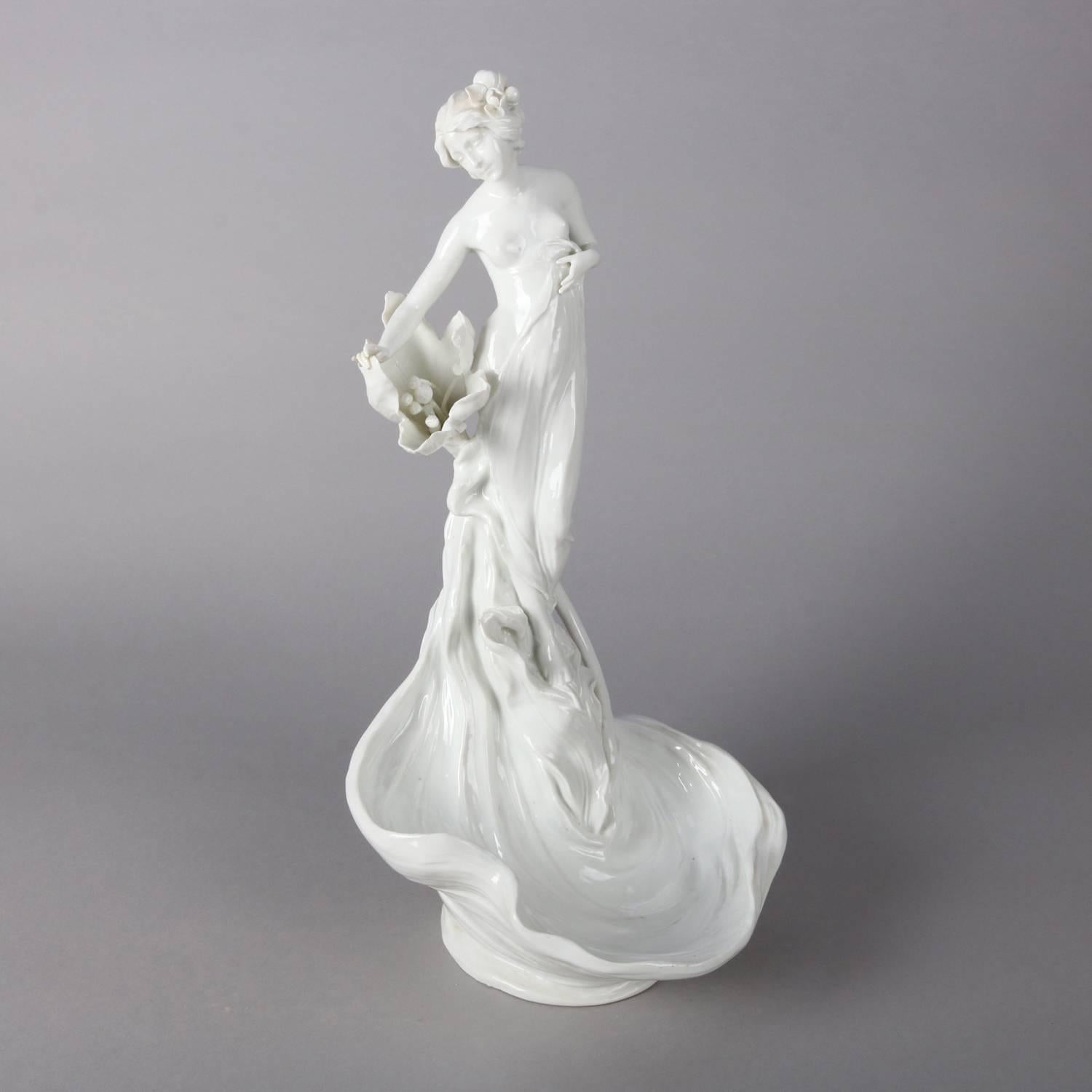 Art Nouveau style figural Blanc de Chine porcelain display bowl features partial nude sculpture portrait of woman with lily flower above water lily pad form basin, 20th century

Measures - 17.5