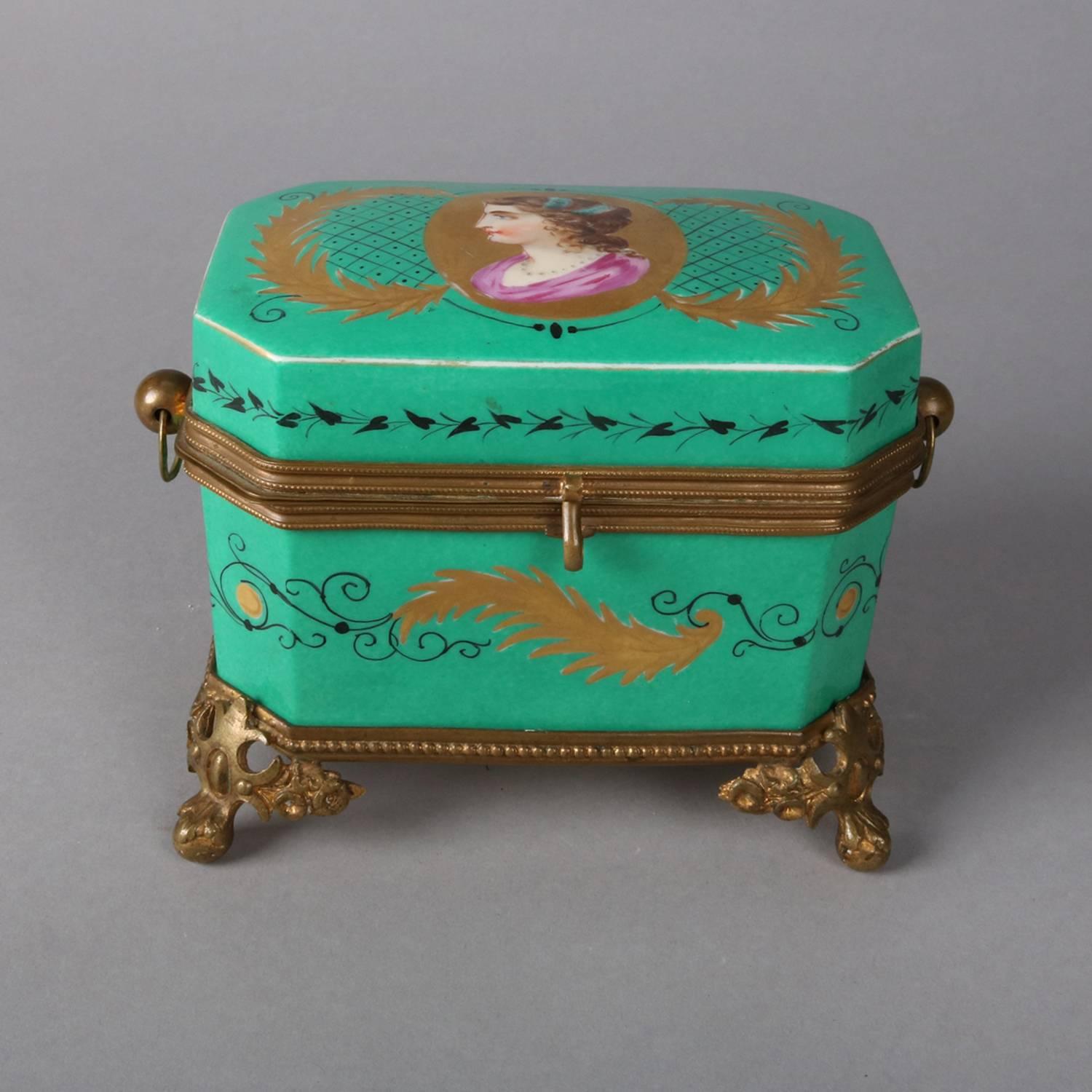 Antique French Sevres school dresser box features hand painted portrait reserve on lid with gilt and painted scroll and foliate decoration, seated on foliate cast bronze footed base and with bronze mounts, 19th century

Measures: 4.5