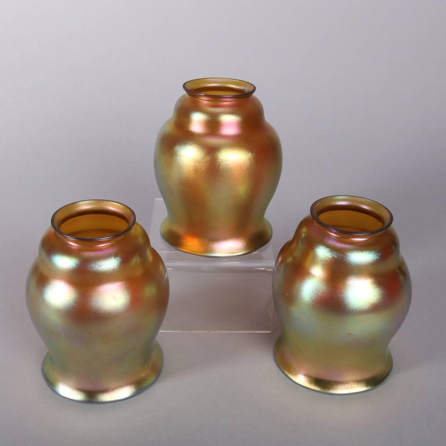 Set of three Arts & Crafts Gold Aurene ovoid form art glass light shades by Steuben, signed, 20th century

Measure: 5