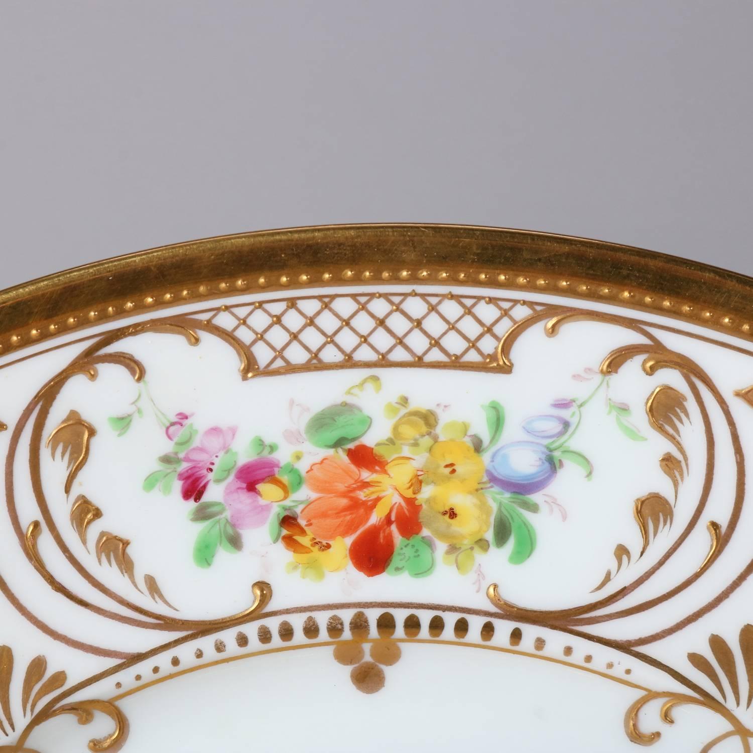 Set of twelve German hand-painted china plates by Rosenthal feature central floral bouquet with scroll, foliate, and diamond gilt decorated border containing floral reserves, en verso mark 