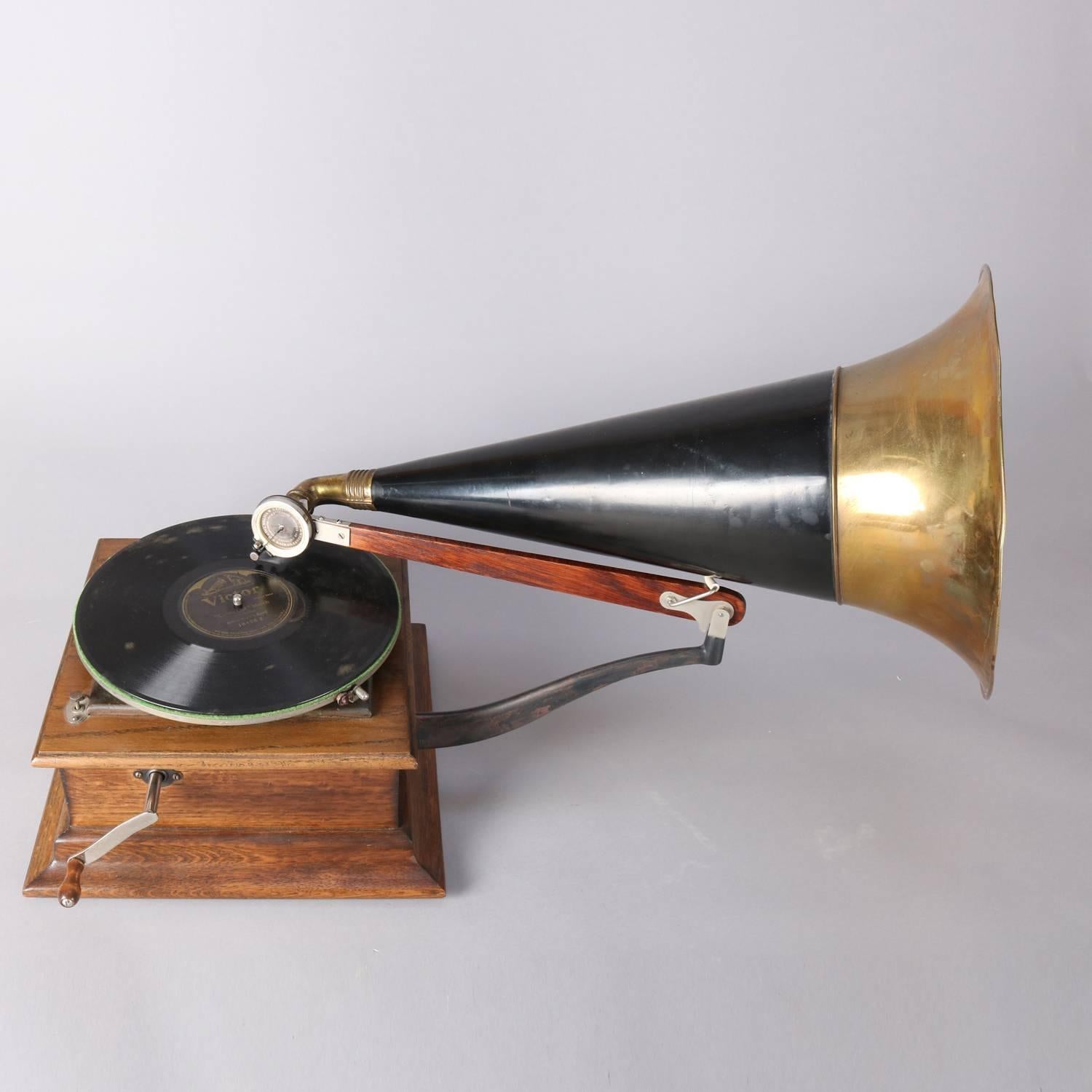 Antique tabletop Victor talking machine phonograph type P. 6858 features oak case, exterior ebonized and brass Horn, original label and metal plaque, working condition, early 20th century

Measures:  20