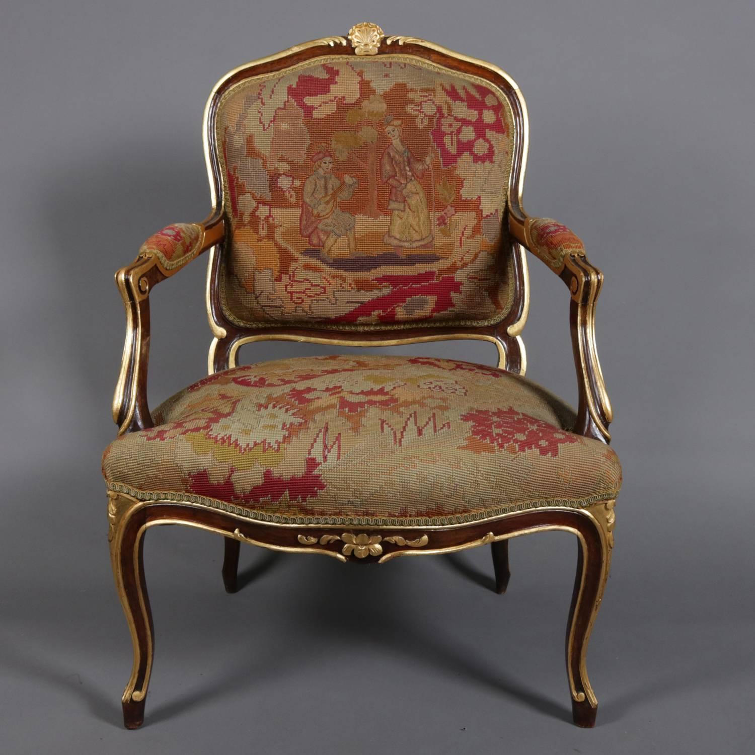 French Louis XVI style fauteuil armchair features fruitwood frame with carved scroll, shell and foliate decoration, highlighted throughout in gilt and seated on cabriole legs; upholstered back, seat and arms are pictorial tapestry with countryside