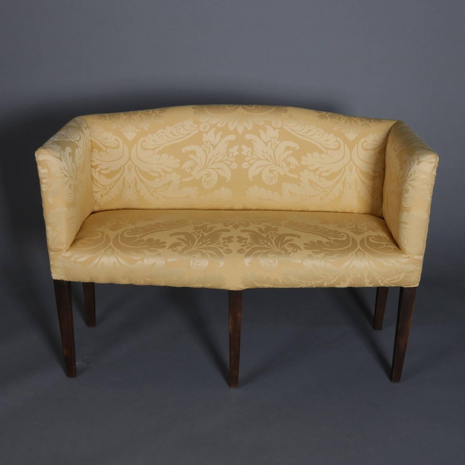 Petite English Hepplewhite style settee features bow back and seated on tapered mahogany legs, 20th century

Measures: 30.5