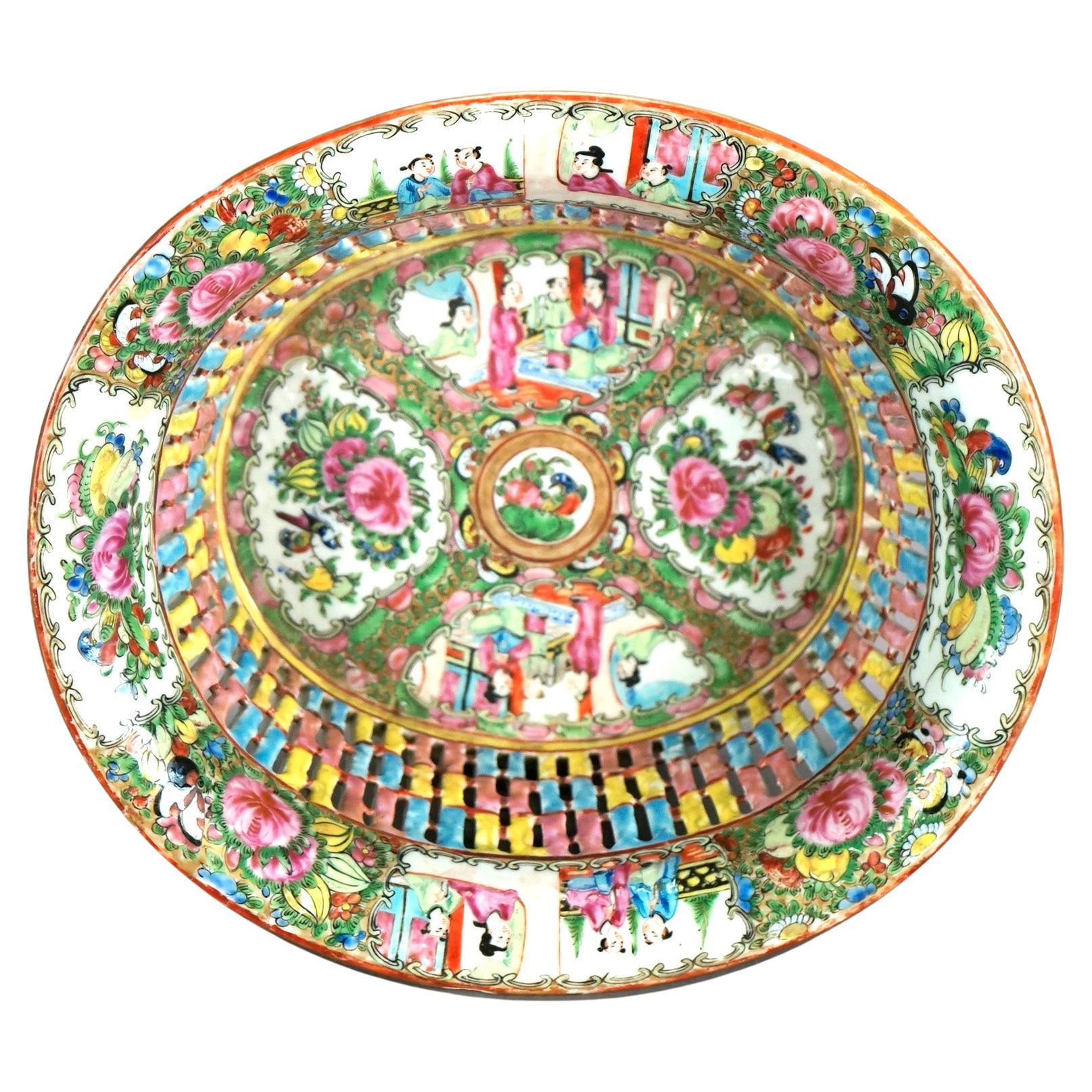 An antique Chinese Rose Medallion basket offers porcelain bowl with reticulated sides and hand painted garden and genre scenes having figures and flowers, c1900

Measures- 4.25''H x 10''W x 11''D