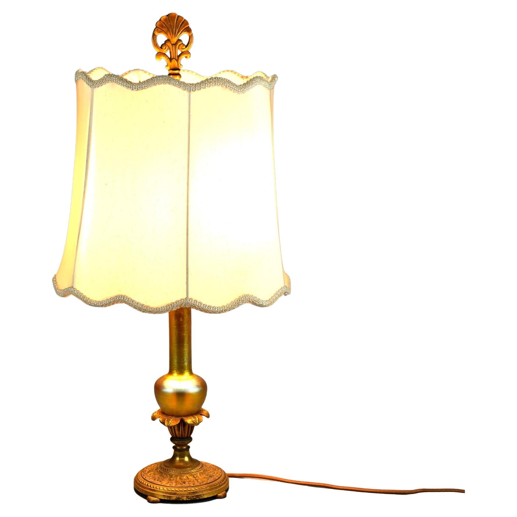 An antique table lamp offers an art glass vase column by Steuben mounted in double socket foliate cast base, c1920

Measures- 25''H x 11.25''W x 11.25''D.