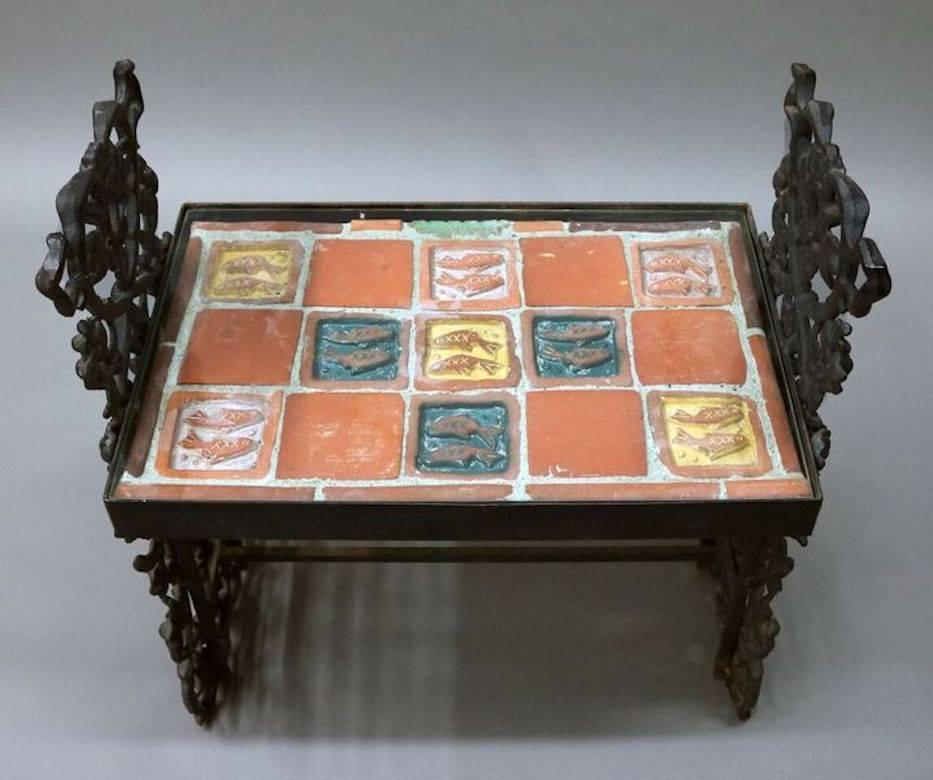 Rare Arts & Crafts Moravian tile top table features fish design terra cotta tiles, foliate cast iron base, and signed with Moravian Campus stamp, circa 1920.