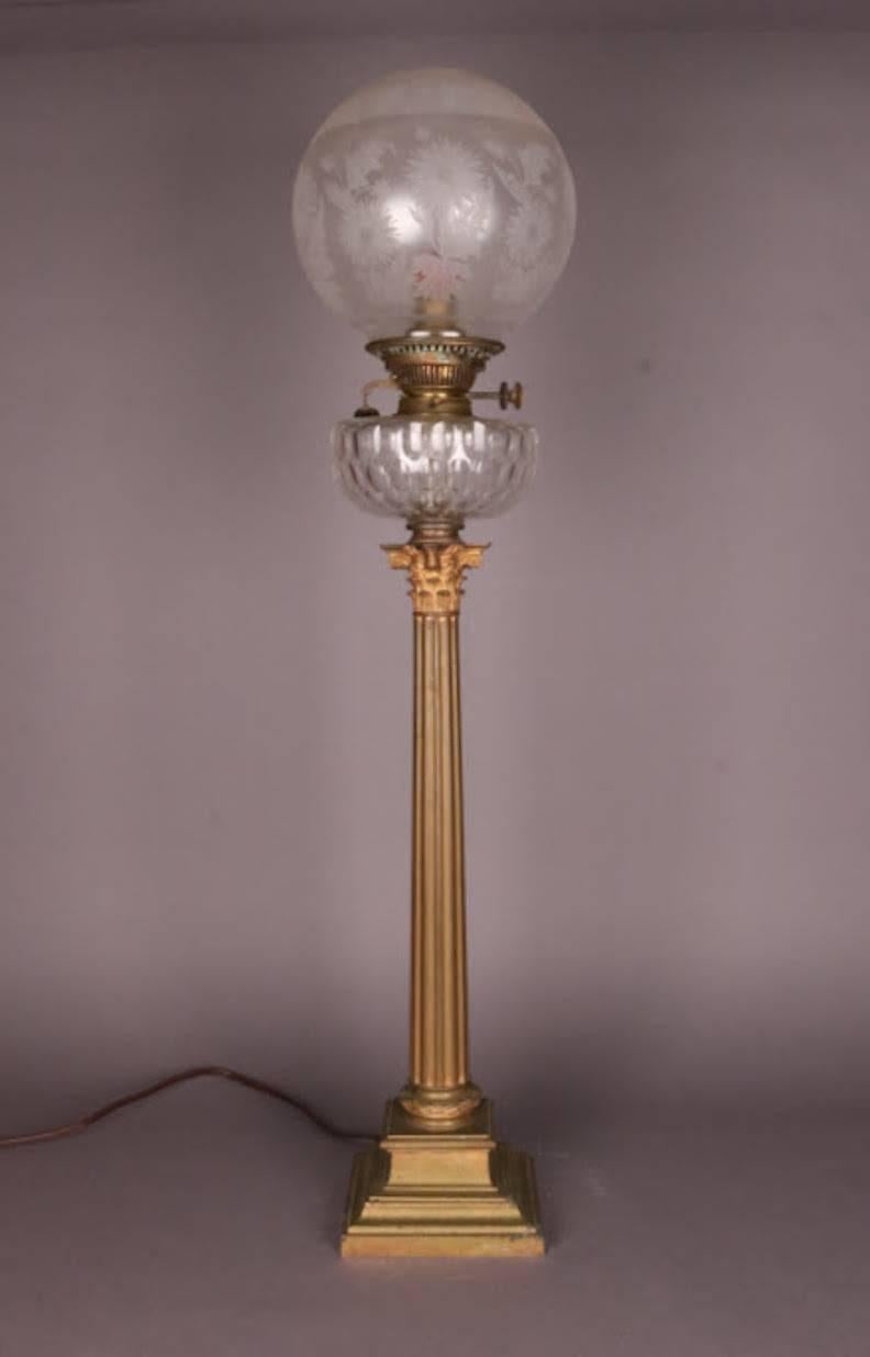 Hinks English Empire electrified banquet lamp features Corinthian column bronze base, thumbprint glass font, and replaced acid etched shade, circa 1840.