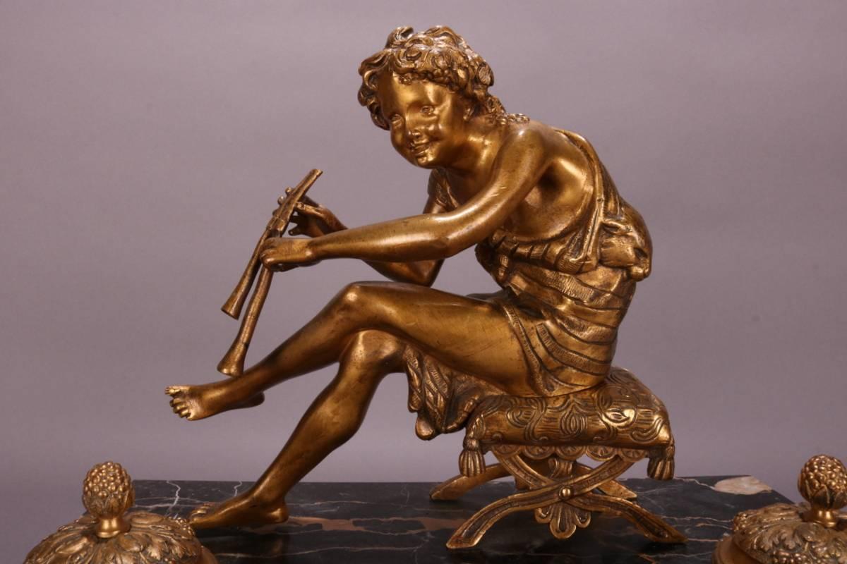 Antique French figural inkwell features bronze Pan with his flute and two inkwells atop a footed marble base, circa 1880. Greek mythological Pan is the god of the wild, shepherds and flocks, nature of mountain wilds and rustic music and companion of