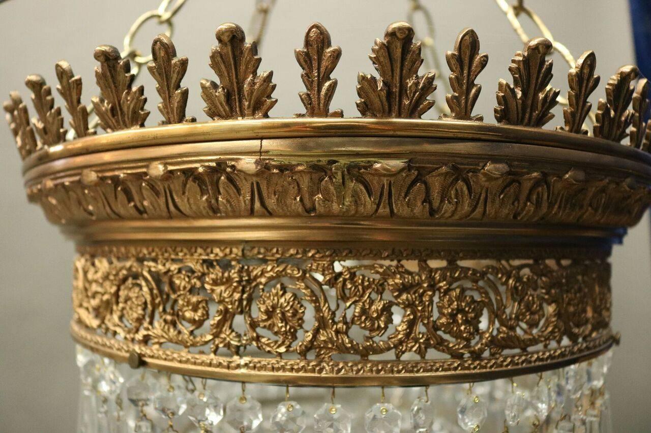 Antique five-tier neoclassical style French wedding cake crystal chandelier with pierced bronze collar. This rare elaborate collar design is reminiscent of a crown, circa 1890.
