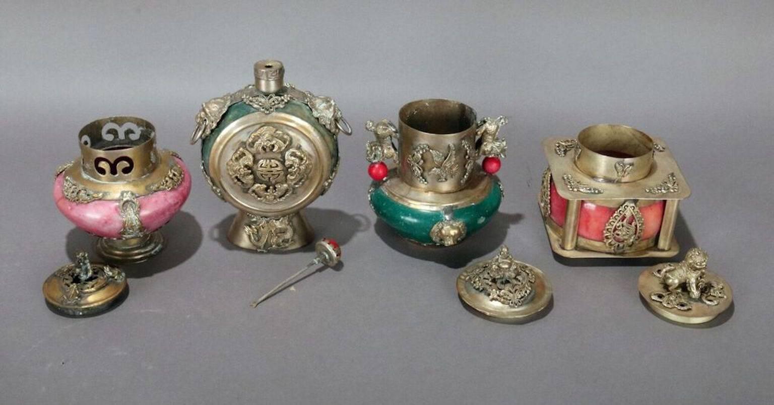 Set of four antique Chinese hard stone scent bottles feature jeweled decoration of copper alloy treated with a silver wash, early 20th century.
