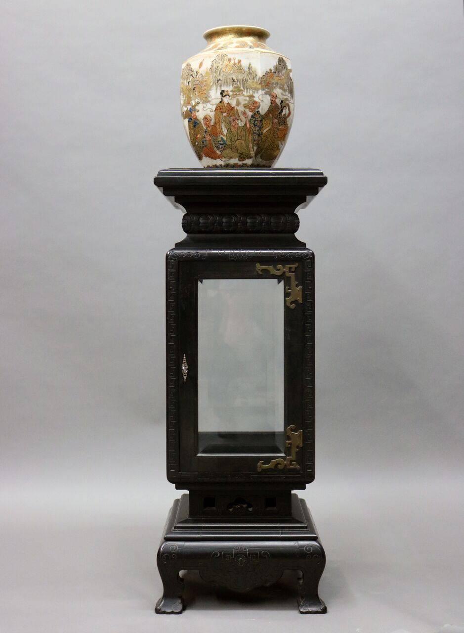 Anglo-Japanese Kimbel & Cabus footed single door curio stand features ebonized hardwood with incised design, mirrored interior back, and bronze hardware, 19th century.

Kimbel and Cabus was a Victorian-era furniture and decorative arts firm based