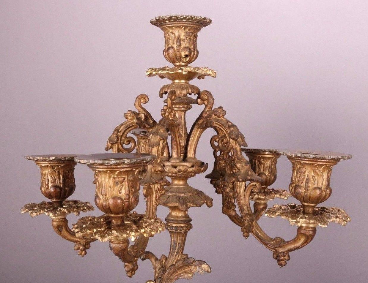 Pair of antique French figural gilt bronze candelabra feature six-lights each, cherub and garden motif, circa 1870.
