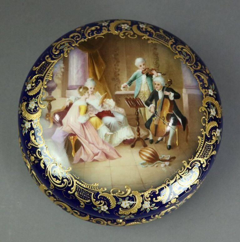 Royal Vienna porcelain oversized dresser box features hinged lid with bronze mounts, hand-painted parlour scene with marriage gilt highlights on Classic cobalt blue field, blue beehive mark on underside, and artist signed 