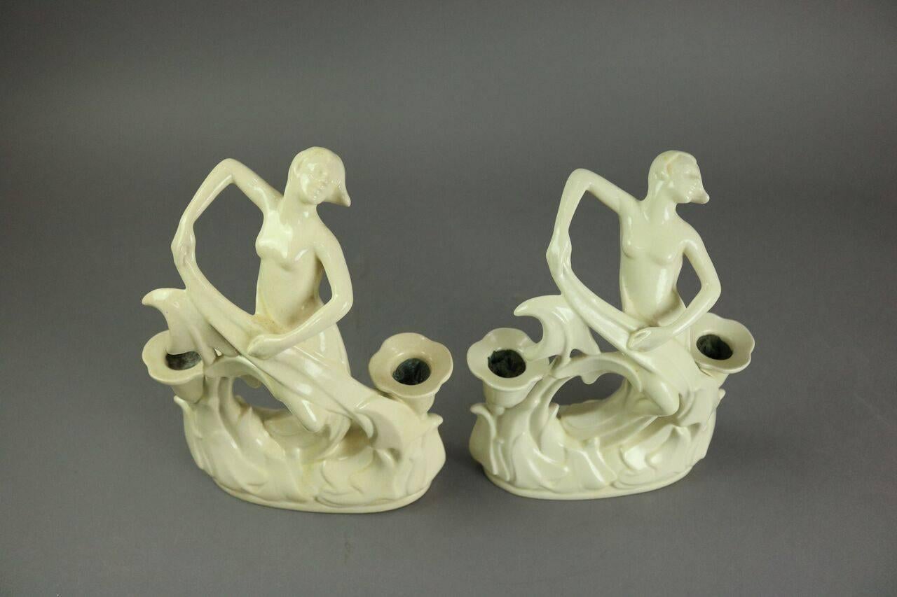 Pair of Art Deco Cowan pottery figural double candlesticks feature dancing women in foliate setting and incised Cowan maker mark on bases, circa 1930.