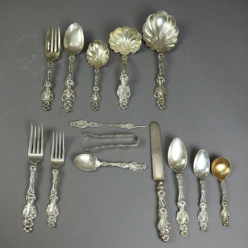 Antique 87 piece sterling silver flatware set in Lily-Floral pattern (#1910) by Frank Whiting, 1910. Service for 12 in box includes - 12 dinner forks (8"), 16 salad forks (6.75"), 22 teaspoons (6.75"), two tablespoons (6.75"),