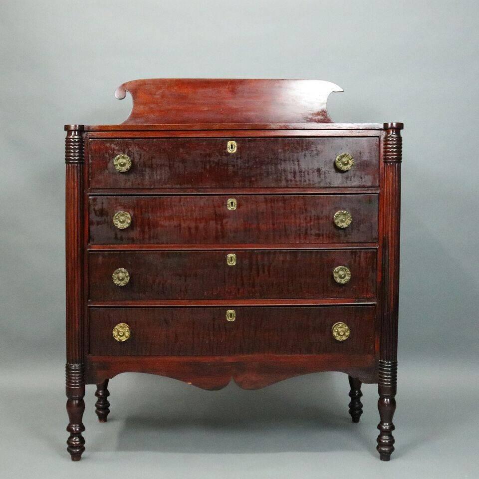 Antique Federal style chest features cherry and tiger maple construction including turned legs, quarter columns and floral embossed bronze pulls, circa 1825.

Measures - 50