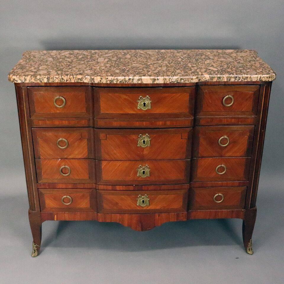 Antique French Louis XVI style butler features mahogany construction with bookmatch kingwood panels with top drawer opening to writing surface with three drawers, all-over three long drawers, bronze mounts, granite top, Conde stamp en verso, circa