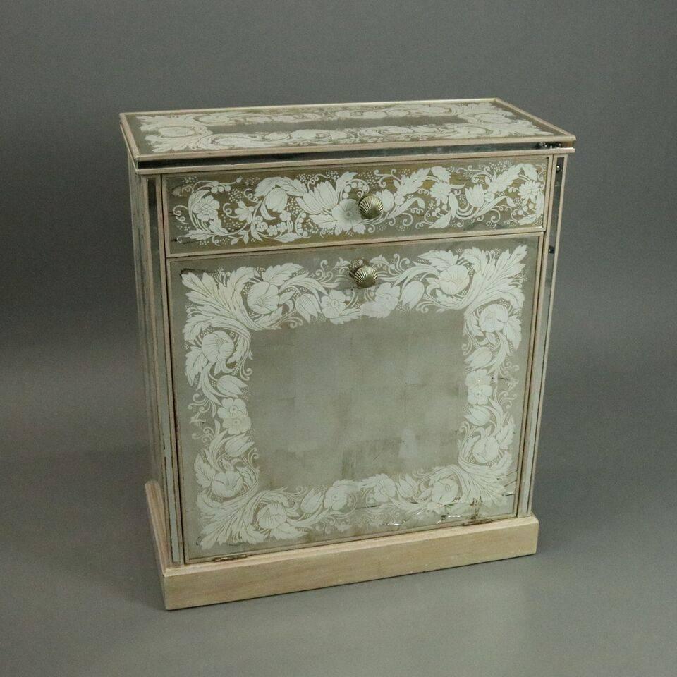 Two pieces of vintage mirrored Venetian style cabinet and vanity features stenciled floral design on mirrored exterior, single drawer with laundry compartment lower and mirrored vanity upper, circa 1960.

Measures - 30" H x 26" W x