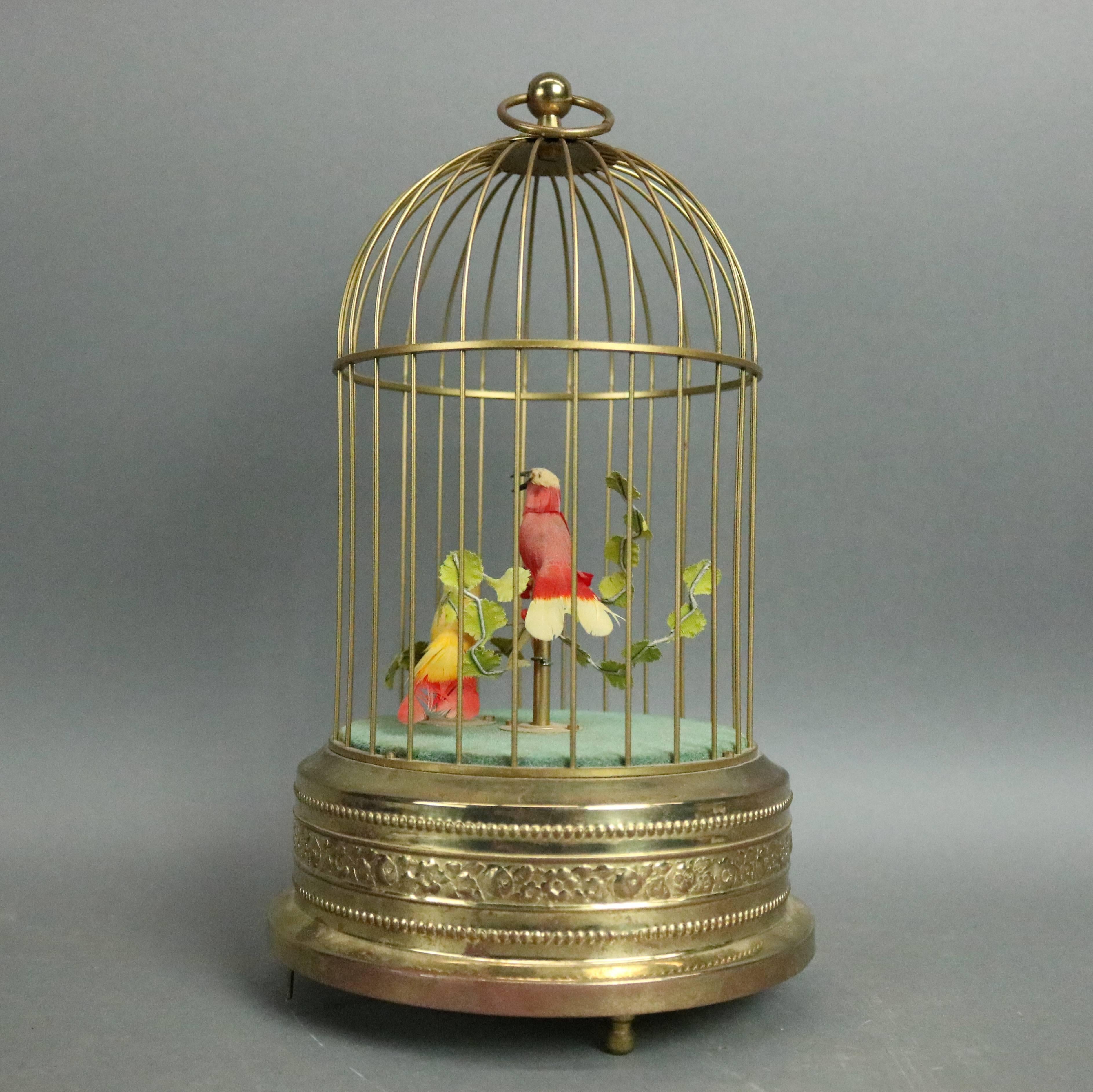 Vintage West German music box features brass bird cage with beaded and floral design, interior animated birds chirp and move their heads and tails in time to the music, base has original West Germany label and Stop Pause Start control, circa