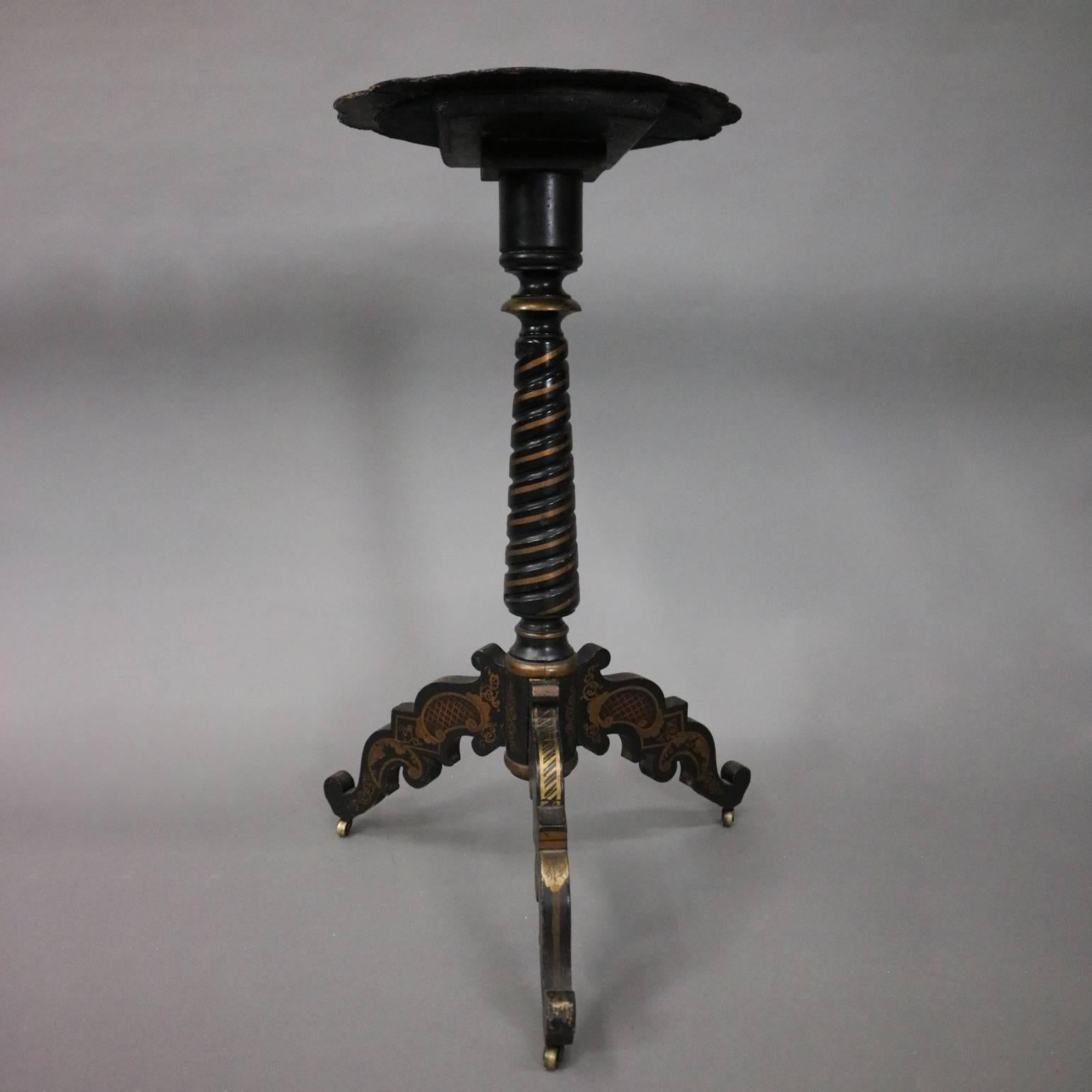 Antique candle stand features hand-painted Romanesque and floral papier mâché tilt top above gilt decorated mahogany tripod stand with twisted rope shaft, circa 1880

Measures - 28"h x 13"diam top, 18"diam base