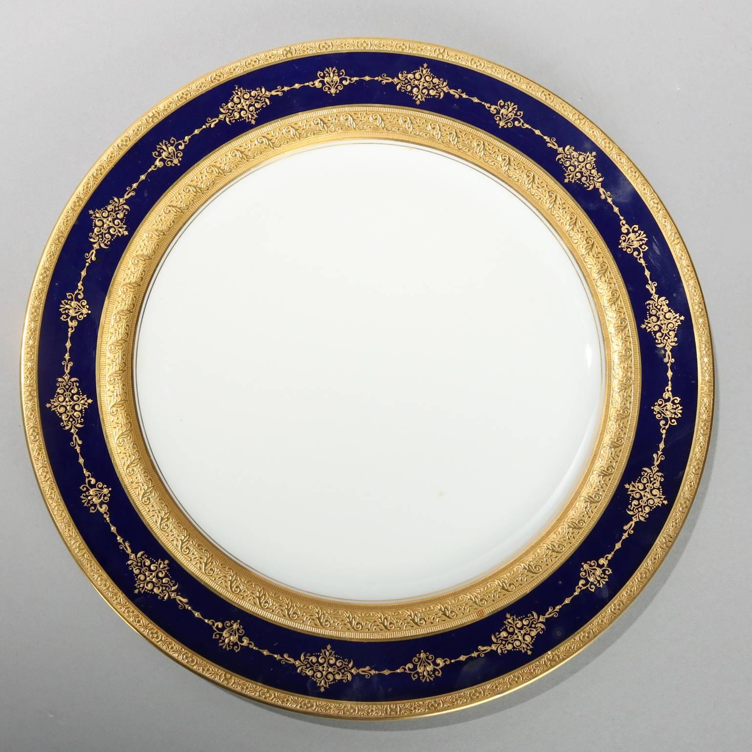 Set of 12 cobalt and gilt dinner plates by Charles Ahrenfeldt Limoges Made Expressly for Ovington's New York and Chicago, 20th century

Measures: 10.25