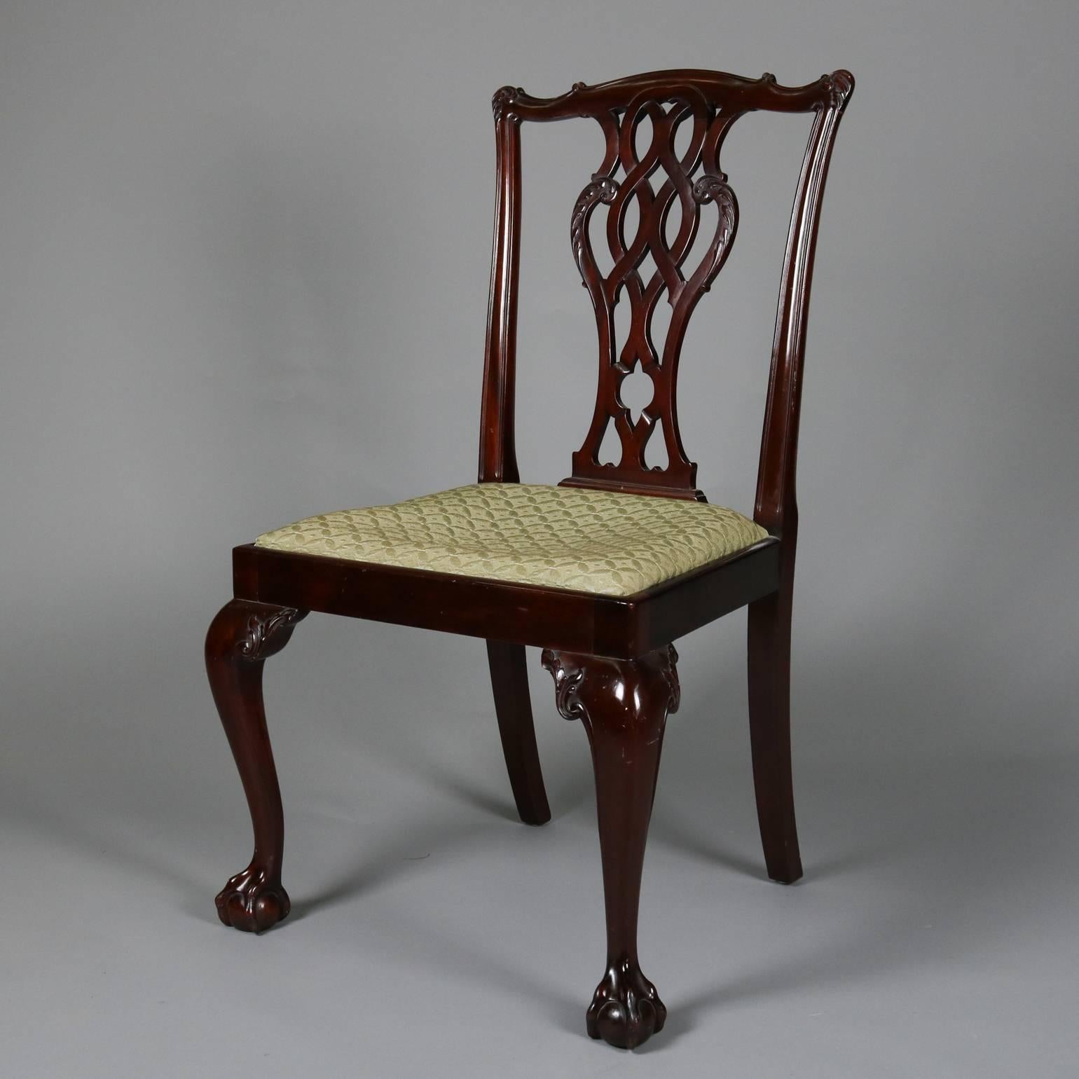 Set of four antique Chippendale dining side chairs feature carved ribbon backs and claw and ball feet, upholstered seats, 19th century.

Measure: 39