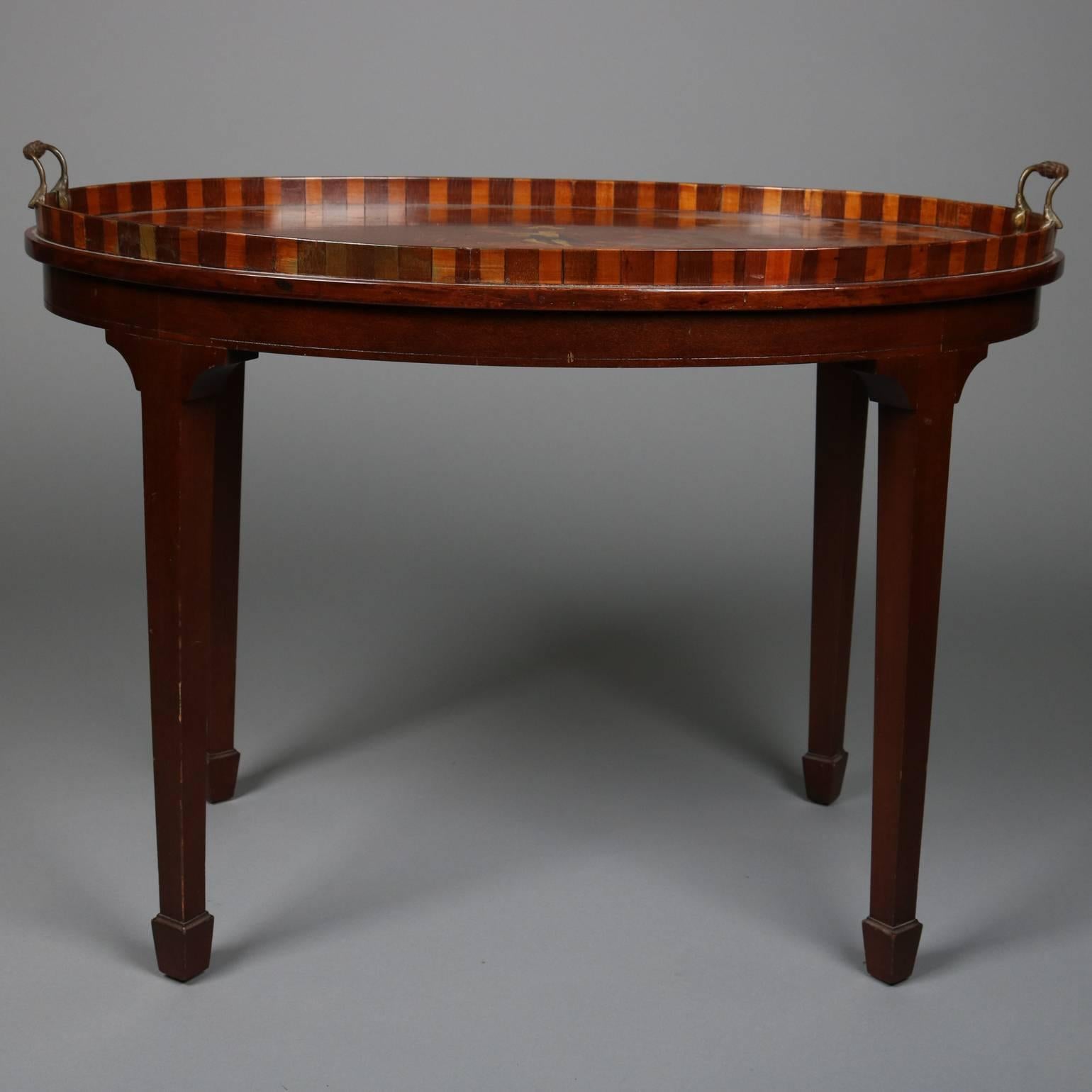Antique Adam style mahogany tea table features double handle tray with neoclassical bone and satinwood inlaid central Greco-Roman figure atop dolphin with bordering figures and foliate inlay, tray lip with alternating two-toned segments, atop stand