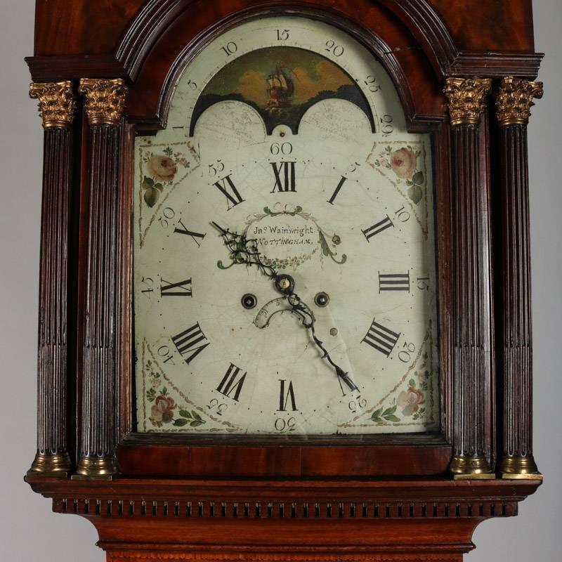 Antique English 8-day rolling longcase clock by John Wainwright, Nottingham features painted arched dial with floral decoration, rolling moon phase, seconds dial and calendar, Roman numerals, mahogany case with swan neck cornice and reeded