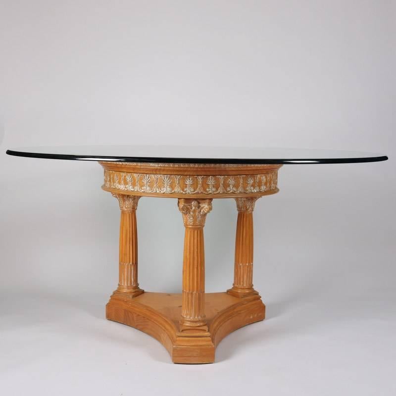 Classical dining table features glass top supported by whitewashed carved wood base with three Corinthian columns, 20th century

Measures: 30.5" height x 59.5" diameter overall, 32" diameter base.