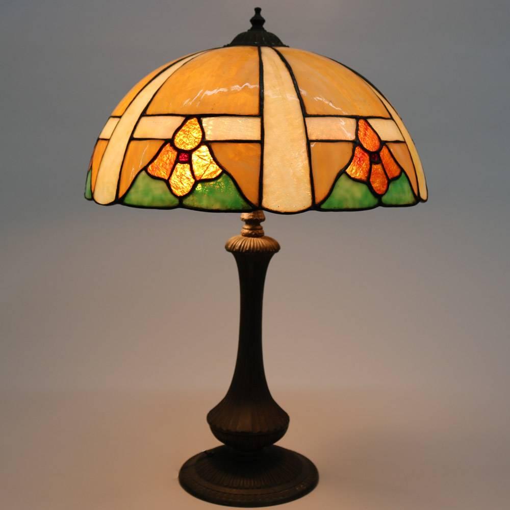 Antique Arts & Crafts Handel School slag glass lamp features stylized floral shade over urn form base, newly rewired, circa 1920

Measures: 23.5" height x 16" diameter.