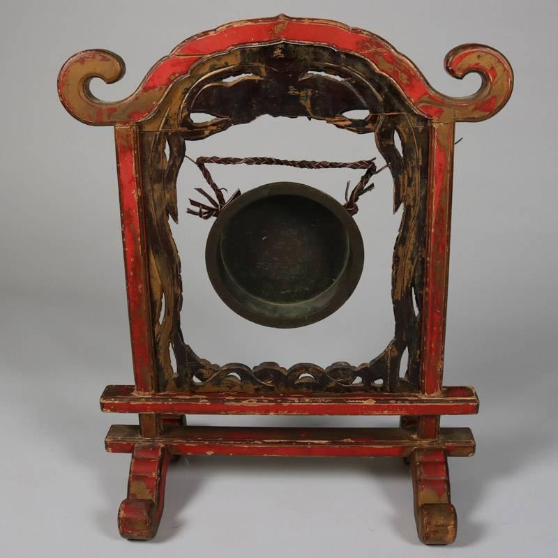 Antique oversized Chinese ceremonial gong features paint decorated, gilt and ebonized pagoda form stand with carved phoenix crest, striker, 19th century

Measures: 27