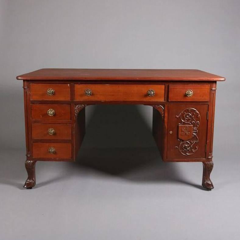 Antique German carved mahogany Black Forest style partners' desk features stag and foliate decoration, cloven hoof feet, drawers are shared and go through both sides

Measures: 29