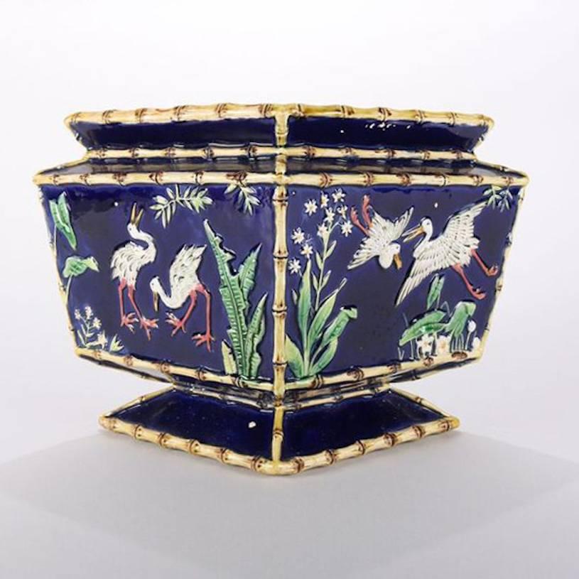 Antique Aesthetic movement Majolica pottery compote by George Jones features egrets in marshland, panels framed in bamboo, GJ mark on base, 19th century

Measures: 7.25
