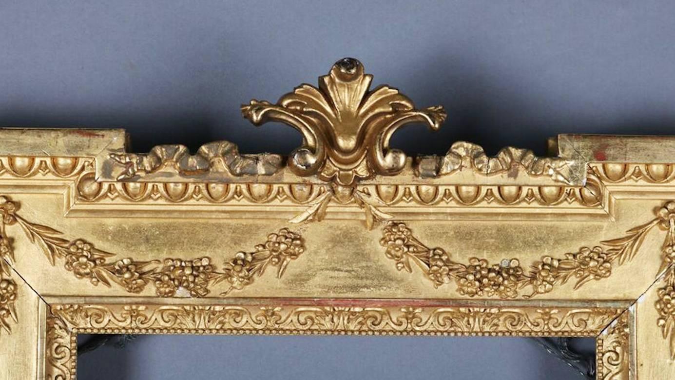 Antique French Empire gold giltwood frame features fleur des lis crest, egg and dart, swag, and beaded decoration, en verso in pencil "Made special for Geo. Rankin & Son", 19th century

Measures: fr: 18.75" H x 13.25" W x