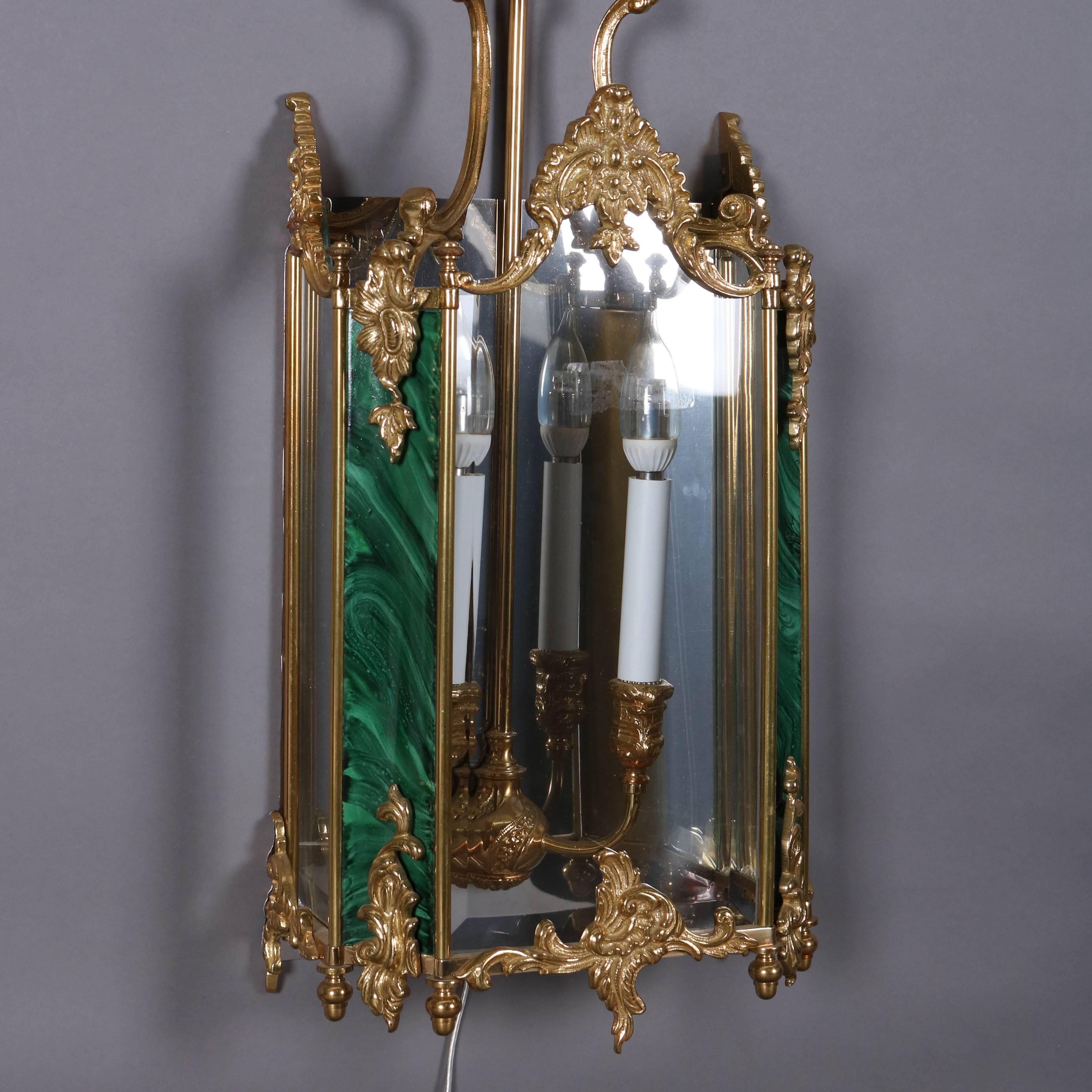 Pair French style gilt bronze and faux malachite panelled mirrored wall sconces, 20th century.

Note: Plug optional, can be hardwired

Measures: 27.5" H x 11" W x 6" D.