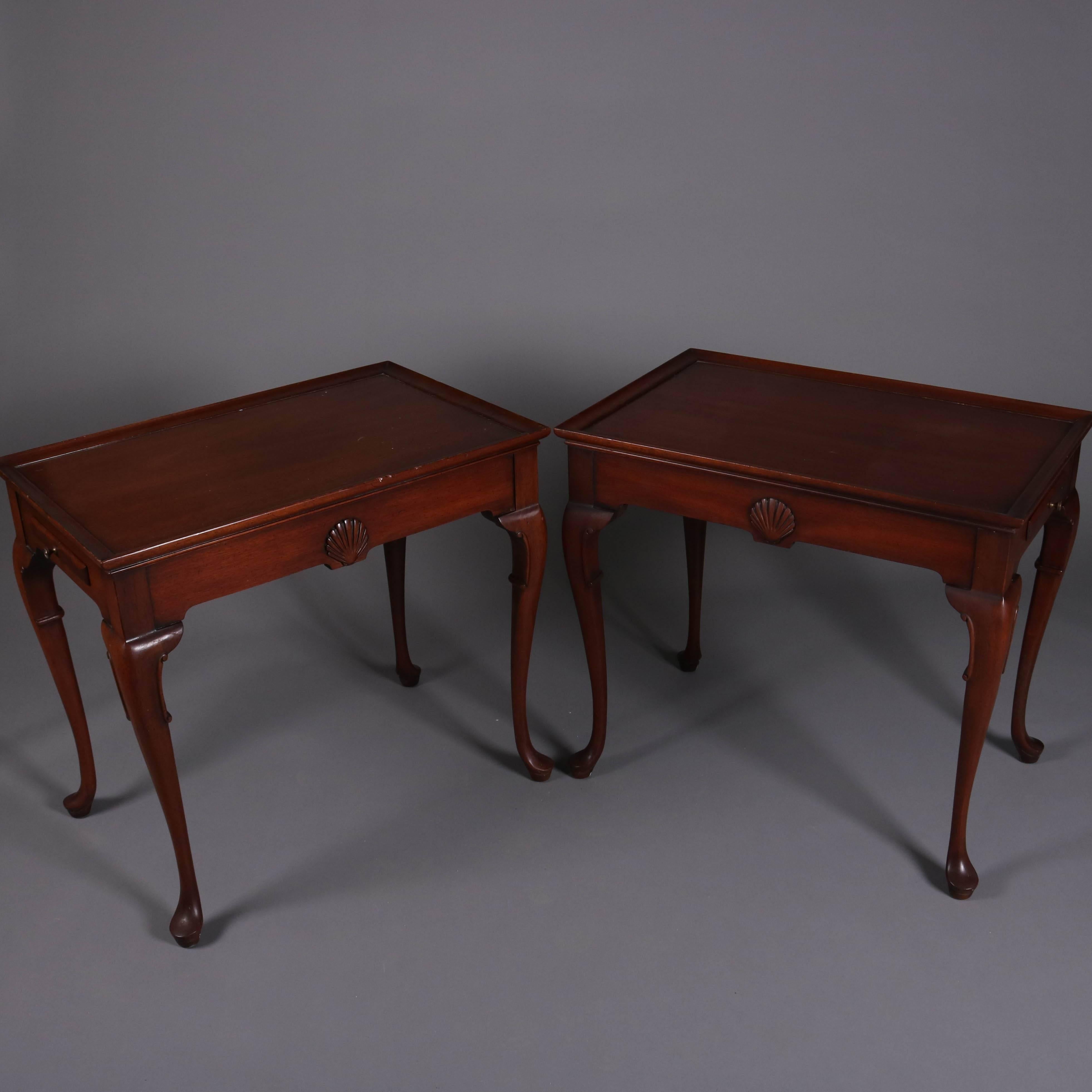 Pair of Queen Anne style Kittinger School mahogany tea tables with candle slides, 20th century

Measures: 25" H x 28" L x 18.5" W.