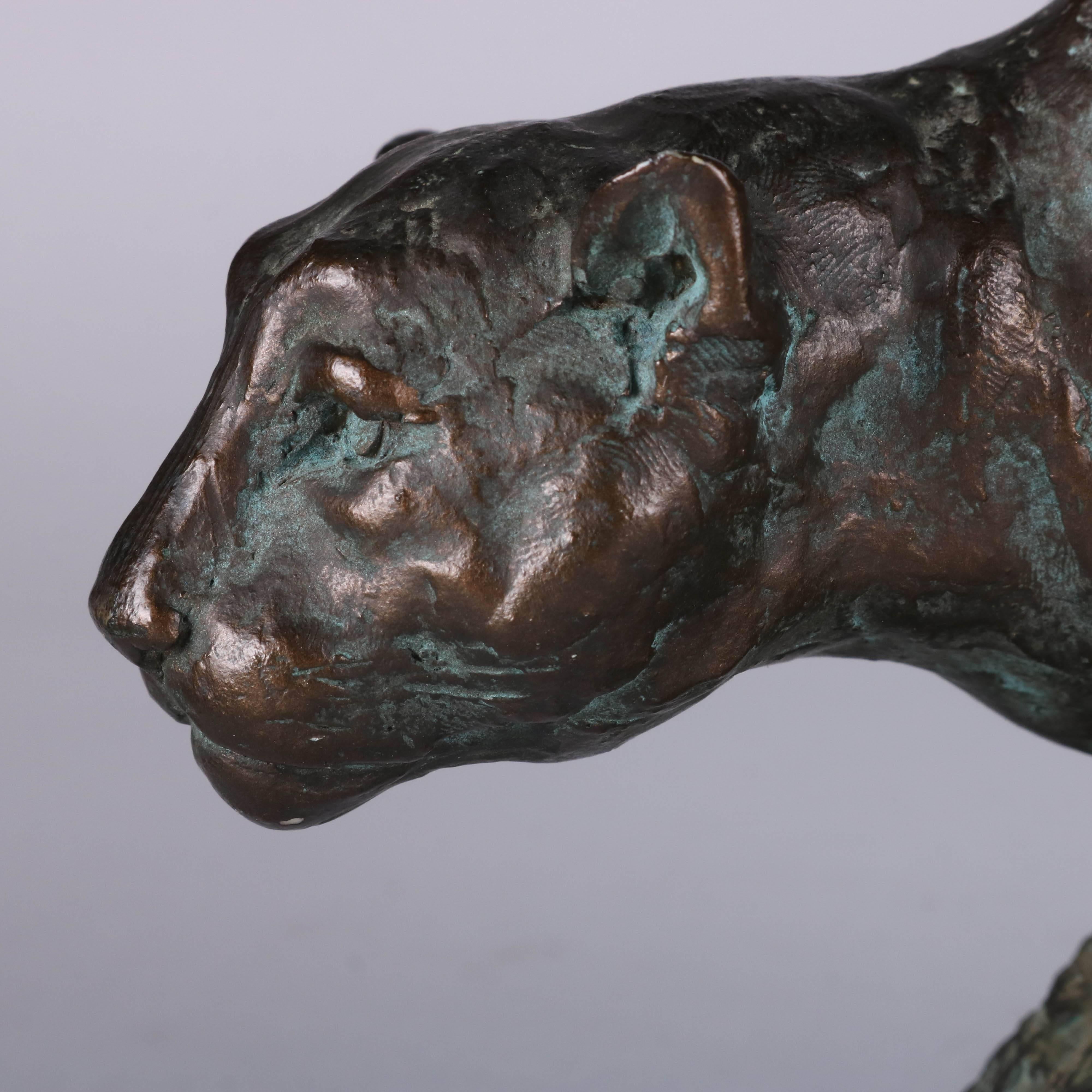Bronzed figural sculpture of a stalking cougar on the hunt

Measures: 6.5" H x 11" L x 4" D @ D.
