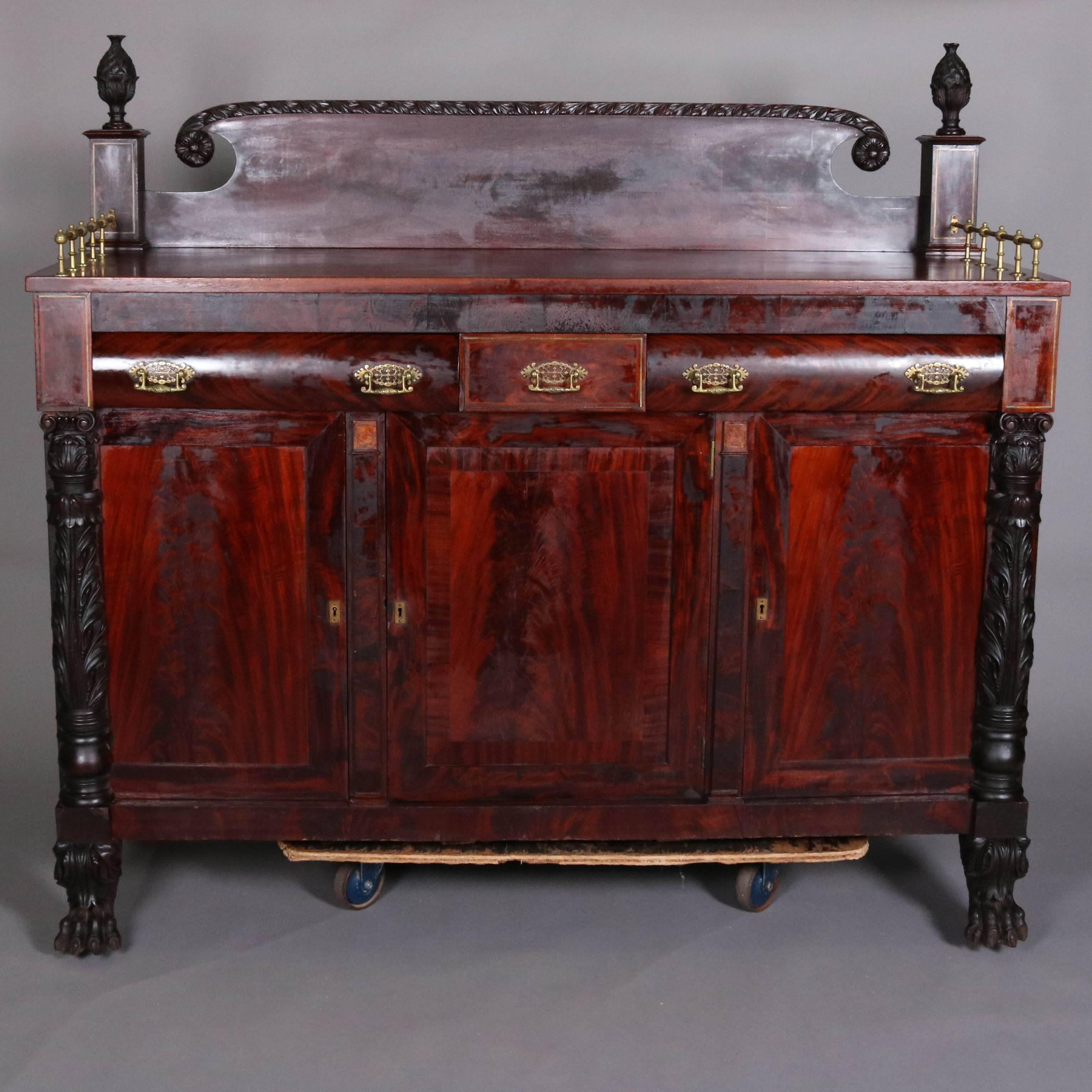 Antique American Empire flame mahogany sideboard carved acanthus Corinthian columns over paw feet, bronze hardware and gallery, 19th century

Measures: 60" H x 65" L x 23" D.