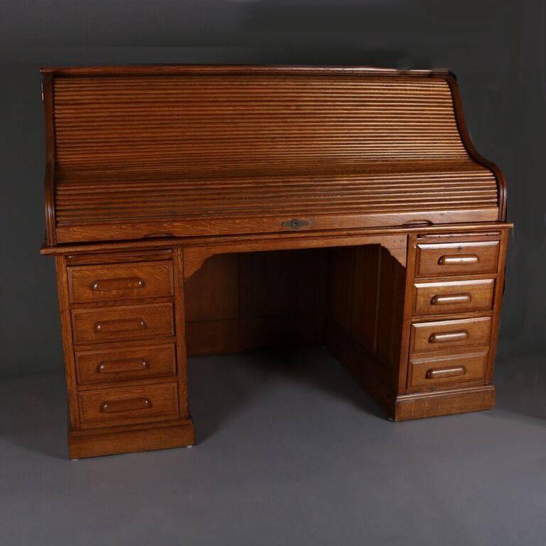 Antique oak roll top desk with swing sides by Derby, Boston, Mass.

Measures: 54" H x 69" W x 36" D, 29" seat H.