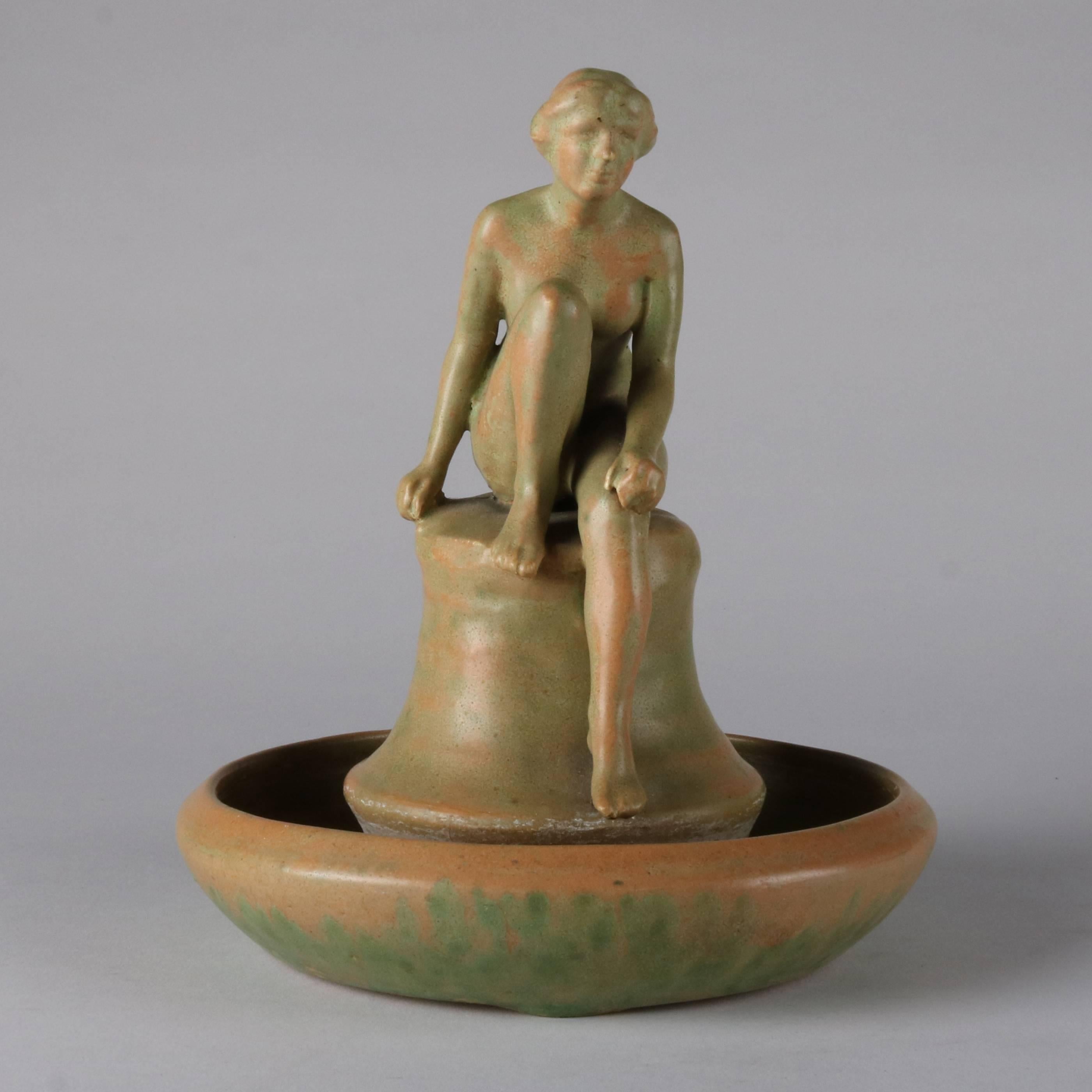 Antique Arts & Crafts figural Walrath art pottery center piece features sculpture of nude woman dipping her feet in pool of water, 20th century

Measures: 8.5" H x 6.5" BS.