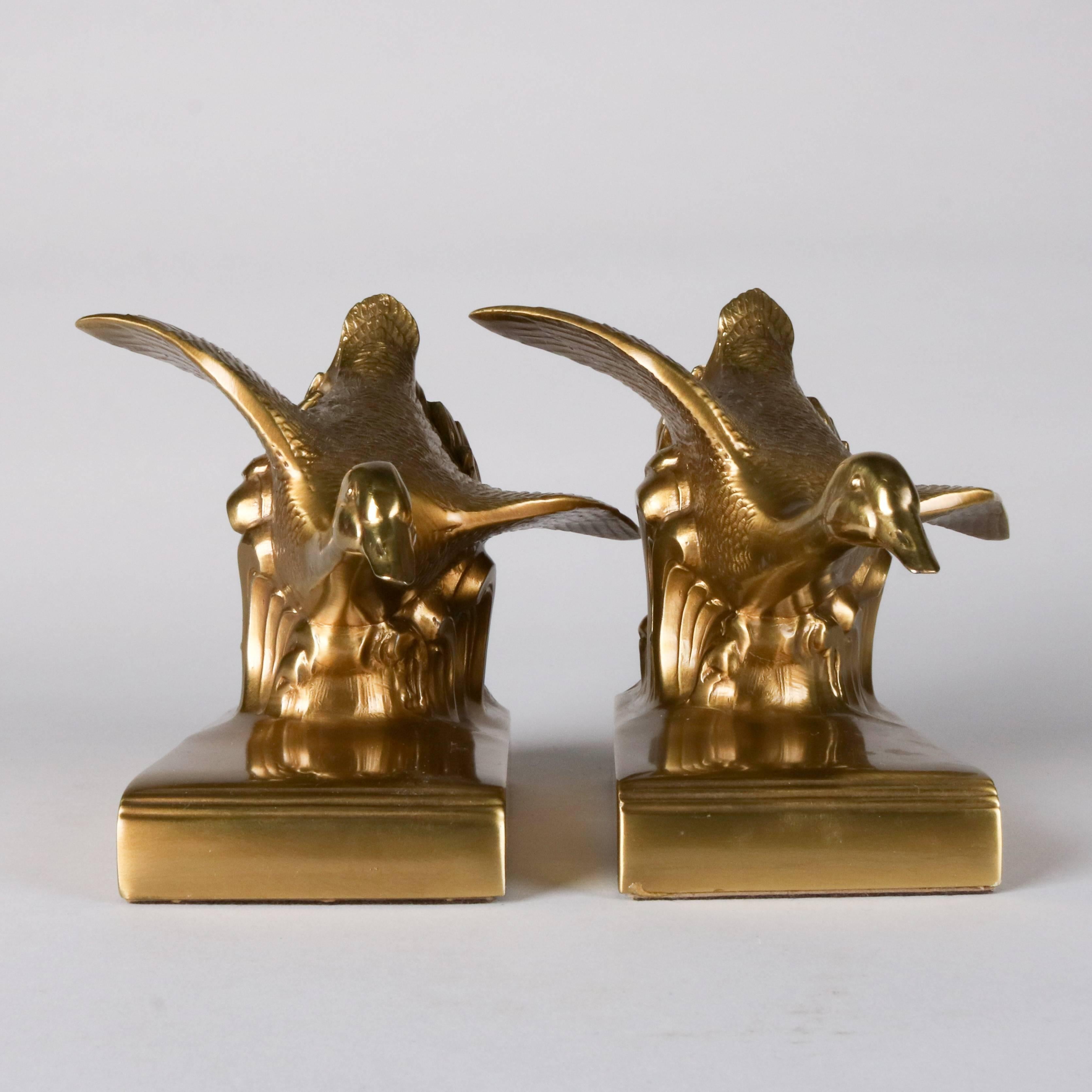 Pair of brass-plated flying geese bookends by Jennings Brothers signed "JB 879"

Measures: 2.25" H x 6.5" L x 6" W.