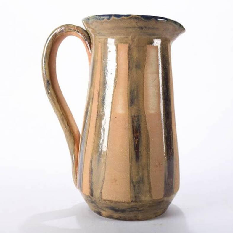 Mid-Century Modern hand-thrown studio art pottery pitcher features striped exterior with cobalt blue glazed interior, mid 20th century
Provenance: Deaccessioned from the Call Museum, Hartsville, New York


Measures - 9.25