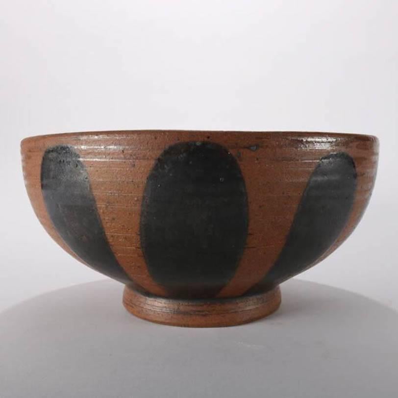 Mid-Century Modern hand-thrown studio art pottery footed centre bowl features black spherical external pattern, stylized sunburst pattern interior, signed "'53" on base, mid-20th century
Provenance: Deaccessioned from the Call Museum,