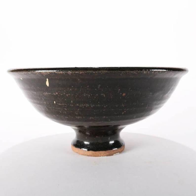 Mid-Century Modern studio art pottery footed centre bowl features central stylized chop mark design, reminiscent of Asian rice bowl, signed, mid-20th century
Provenance: Deaccessioned from the Call Museum, Hartsville, New York


Measures - 5