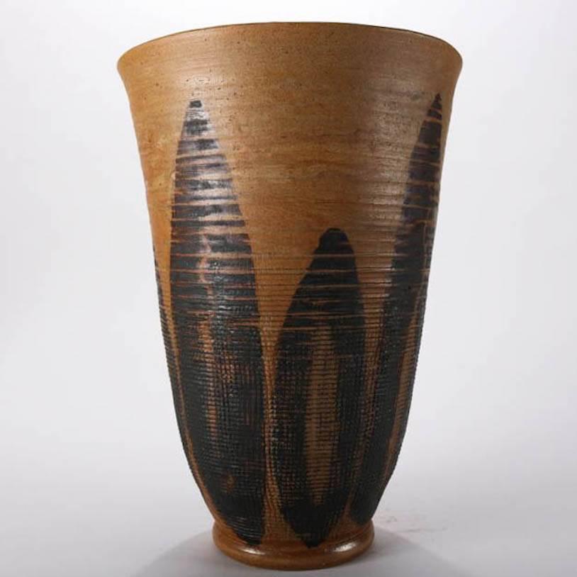 Mid-Century Modern hand-thrown tall vase features flared form with textured exterior of stylized maize corn and leaf motif, mid-20th century
Provenance: Deaccessioned from the Randy Webb Collection of the Call Museum of Hartsville, New York,