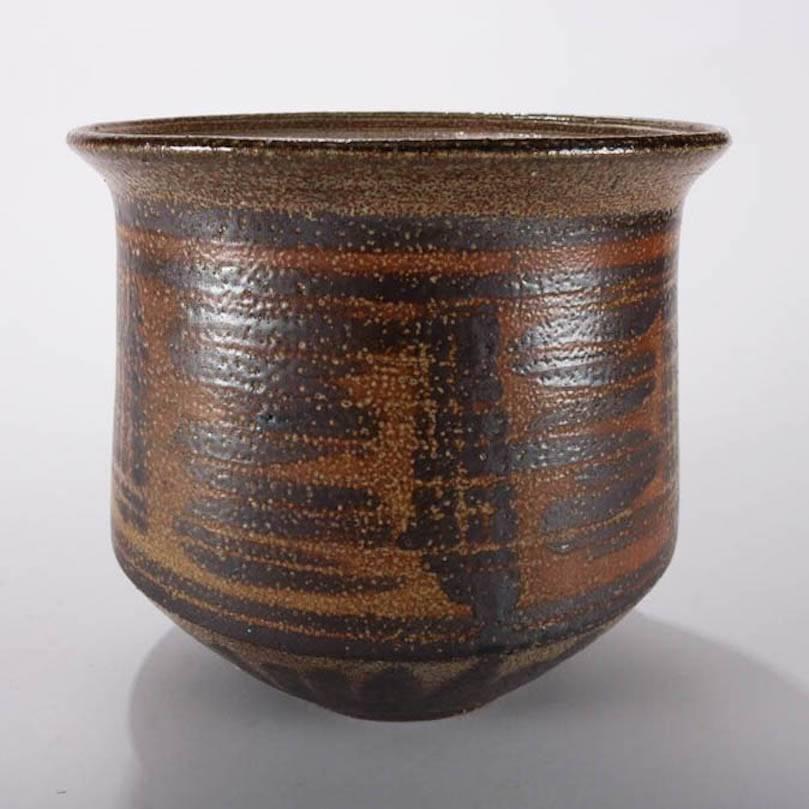 Mid-Century Modern hand-thrown pot features highly textured brown and black decorated salt glaze with tribal motif, raised bowl form with flared lip, mid-20th century, unsigned portfolio piece
Provenance: Deaccessioned from the Randy Webb Collection