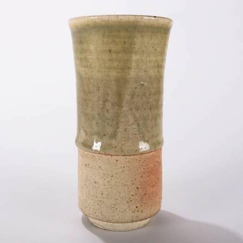 Mid-Century Modern hand-thrown studio art pottery petite vase features green and natural glazing, low gloss finish, divided and flare form with footed base, mid-20th century
Provenance: Deaccessioned from the Randy Webb Collection of the Call Museum