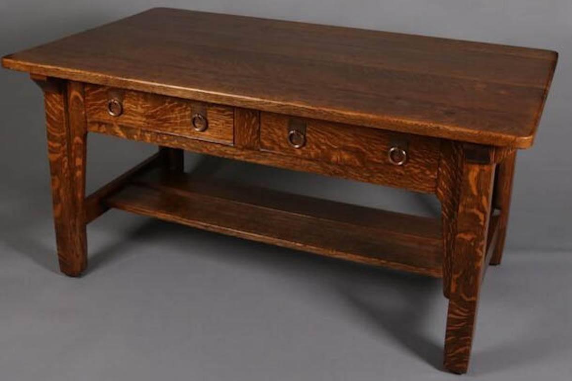 Antique Stickley Brother's Mission Oak Library Table features quarter sawn oak construction with traditional "form follows function" simple lines with two drawers over tray stretcher, copper pulls, model #2502, circa 1910

Measures -