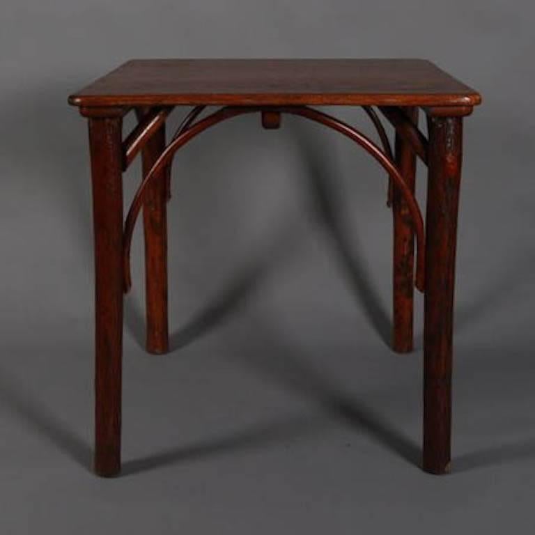 Antique Old Hickory Adirondack style side or occasional table features branch and bentwood frame supporting finished top, 19th century

Measures - 30" H x 30" W x 30" D 